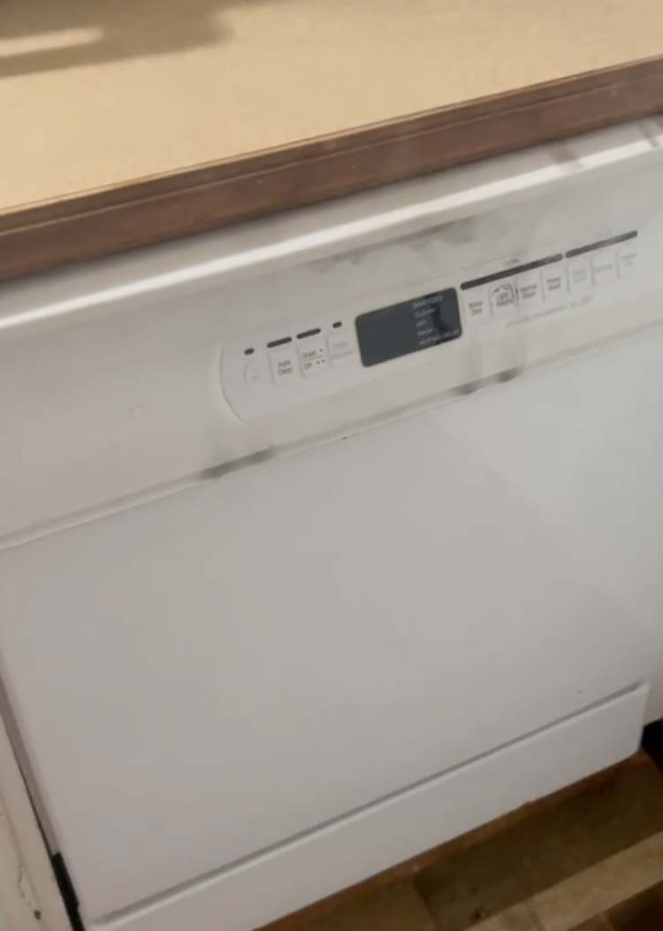 a dishwasher smoking in a kitchen