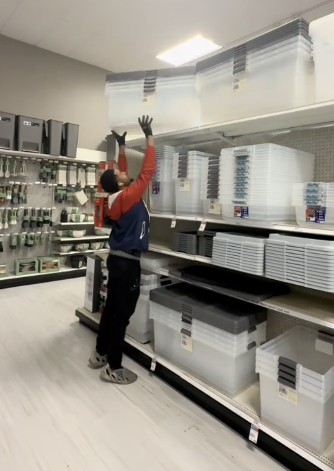 man loading shelves in a store