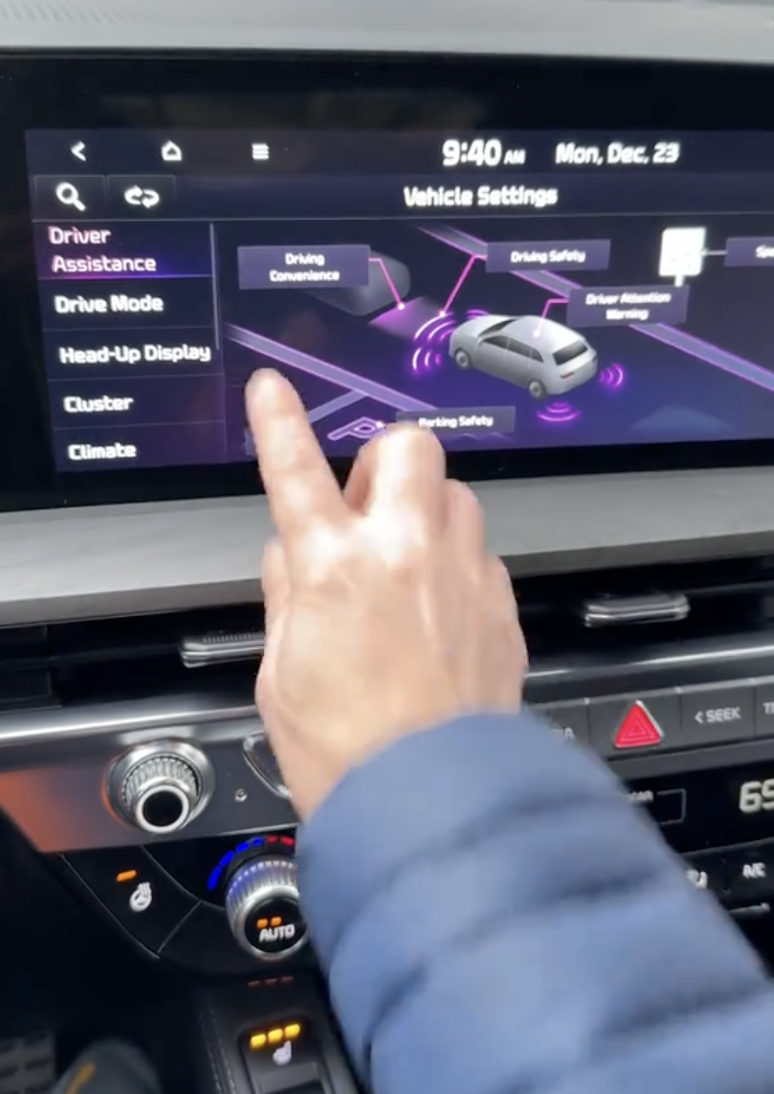 woman pointing out car features