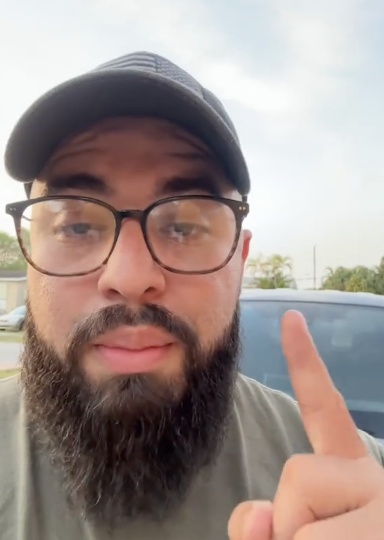 man with a beard, glasses, and a hat