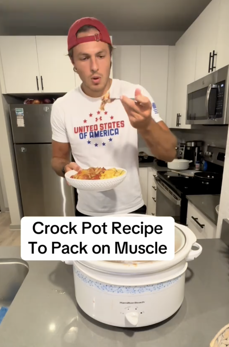 man in a kitchen with a crock pot