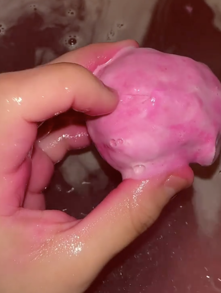 woman holding a bath bomb