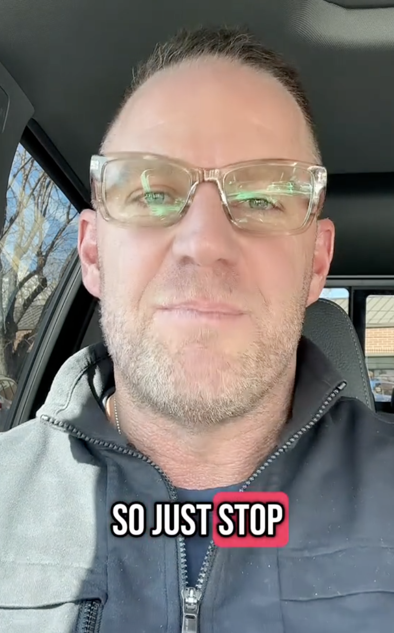 man in his car wearing sunglasses