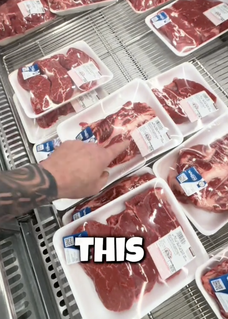 man looking at steak