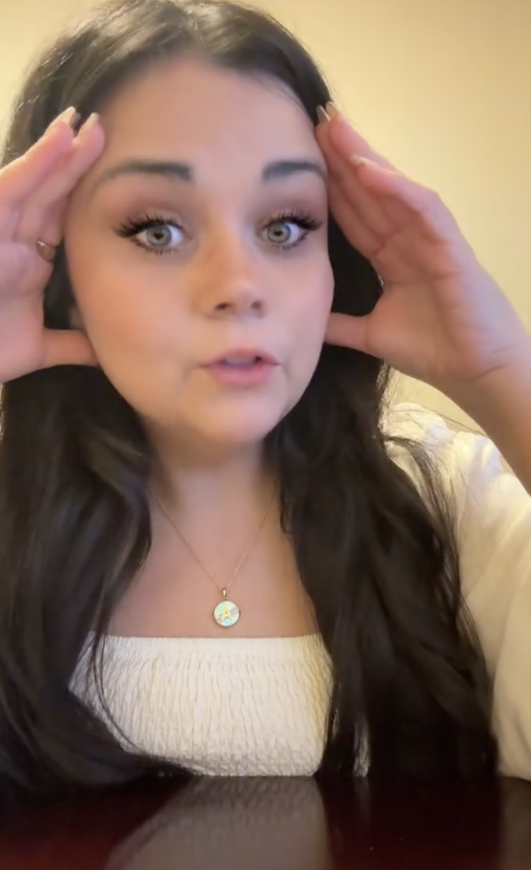 woman with brown hair talking to a camera