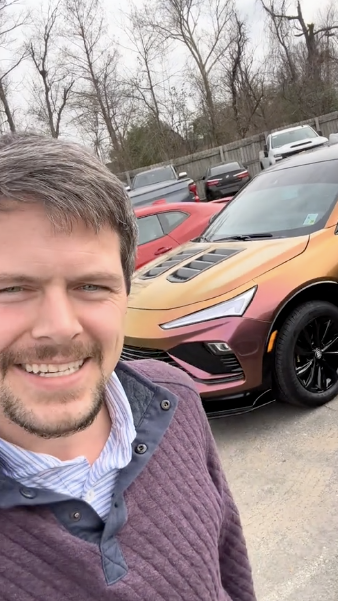 man standing in front of a car