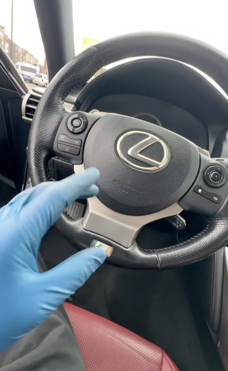 man sitting inside a lexus