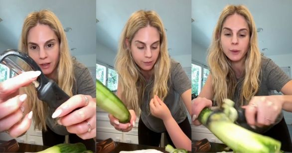 Woman peeling cucumber