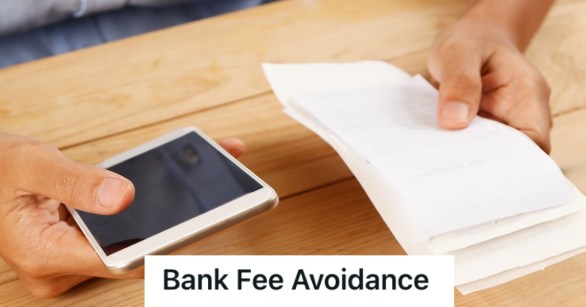 Man holding a phone in one hand and a bill statement in anotehr hand