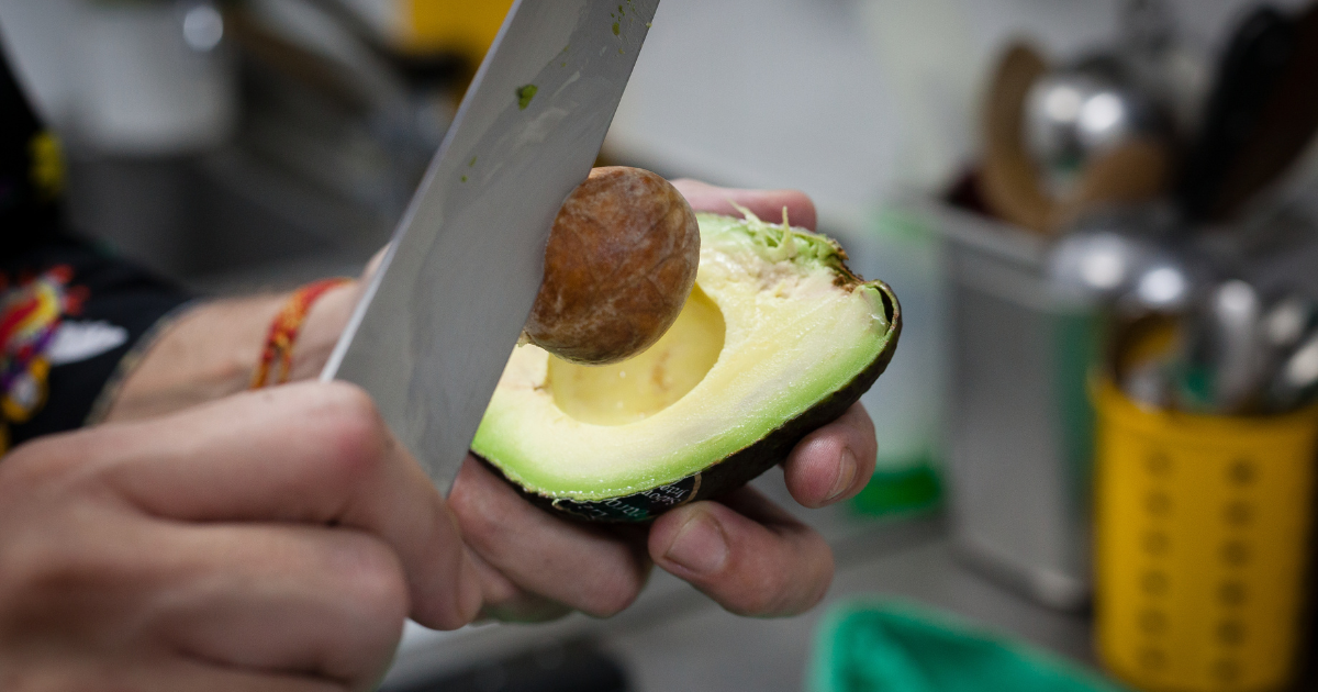 Knife Dangerously Chopping Avocado Seed