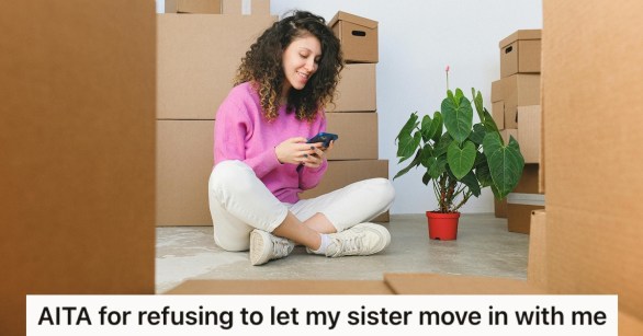 A woman surrounded by moving boxes and a plant