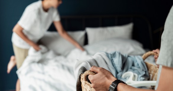 Couple changing bedding