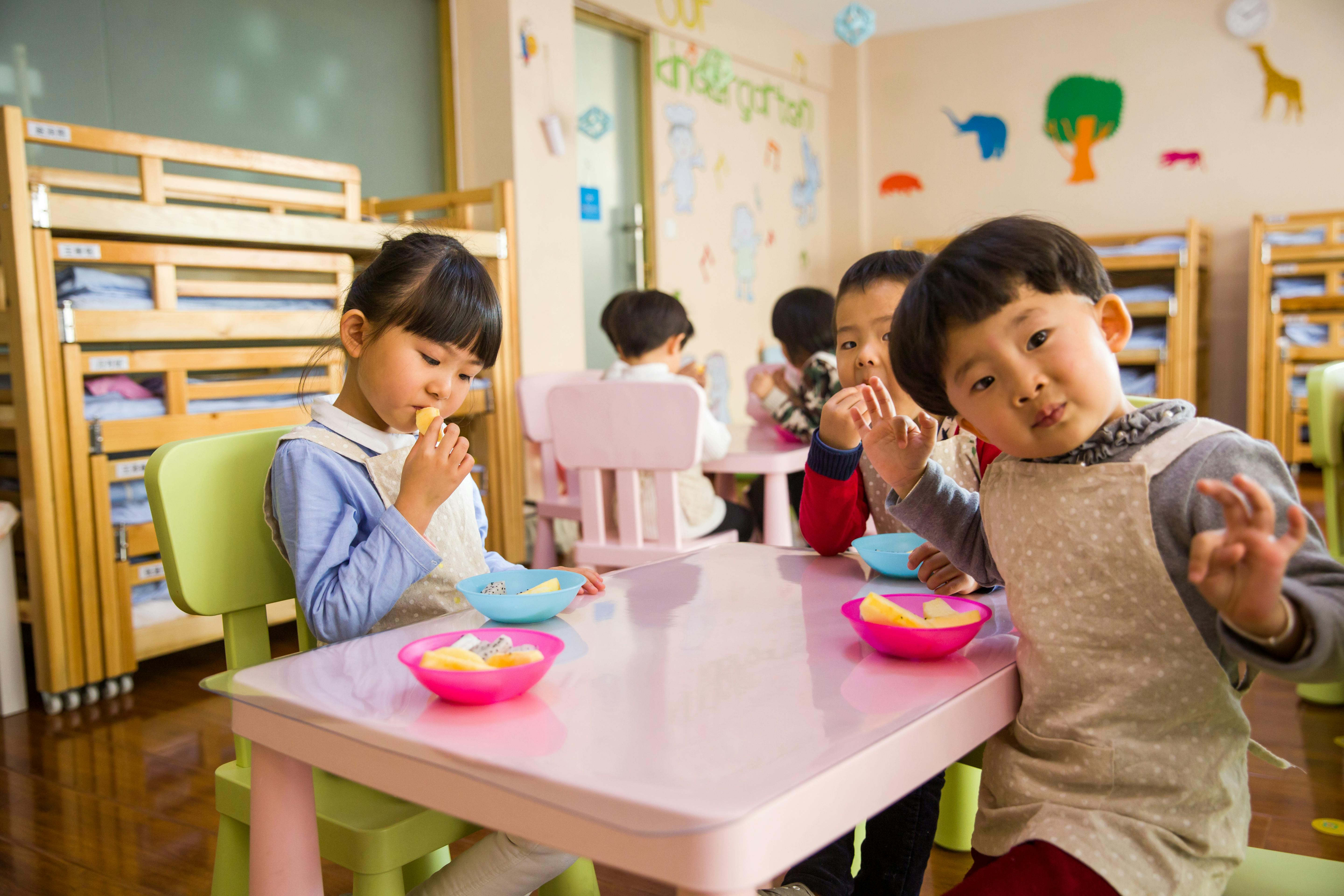Three children eating together at school