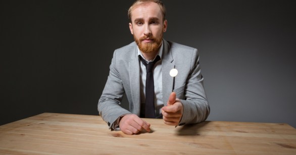 Man in suit tossing a coin