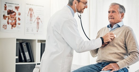 Doctor checking heart of patient