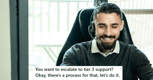 Man in black sweater working and smiling