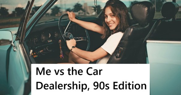 Woman in vintage car holding steering wheel