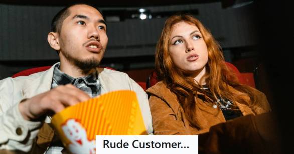 A man and woman upset they're so close to the movie screen