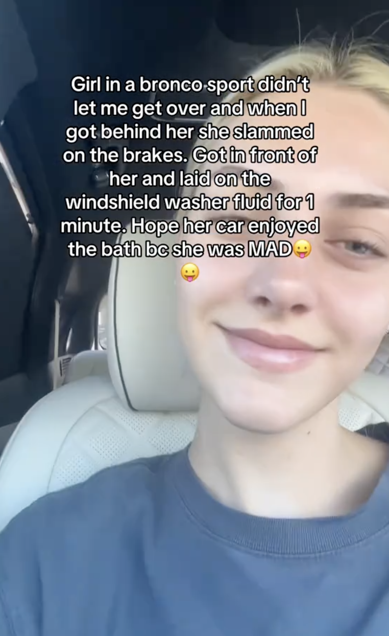 young woman sitting in her car