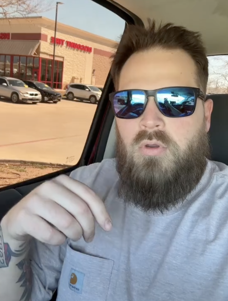 man talking in his car