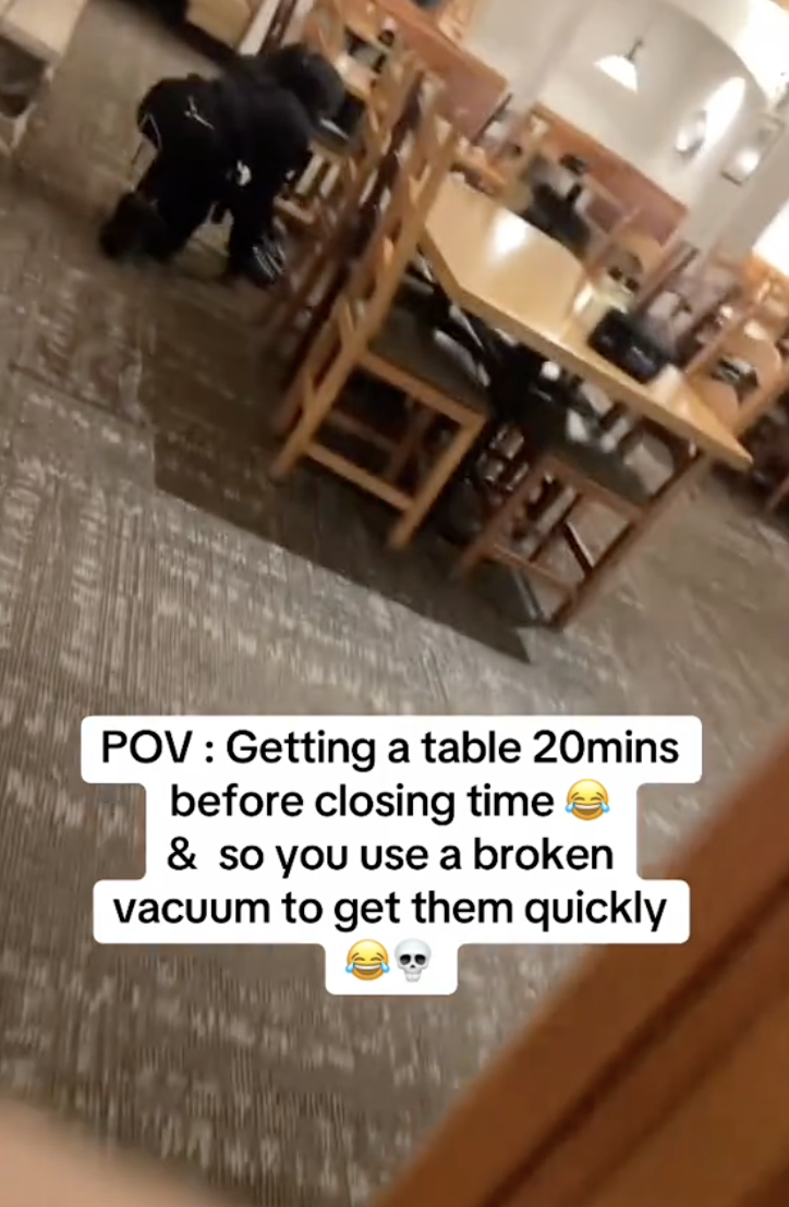 person vacuuming in a restaurant