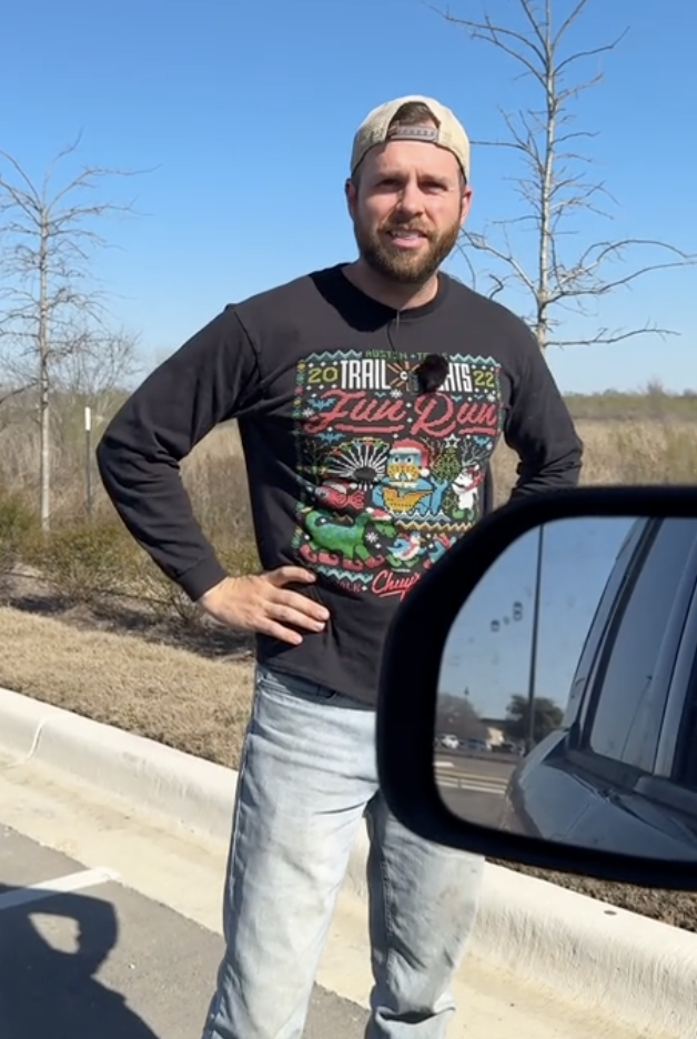 man standing by a car