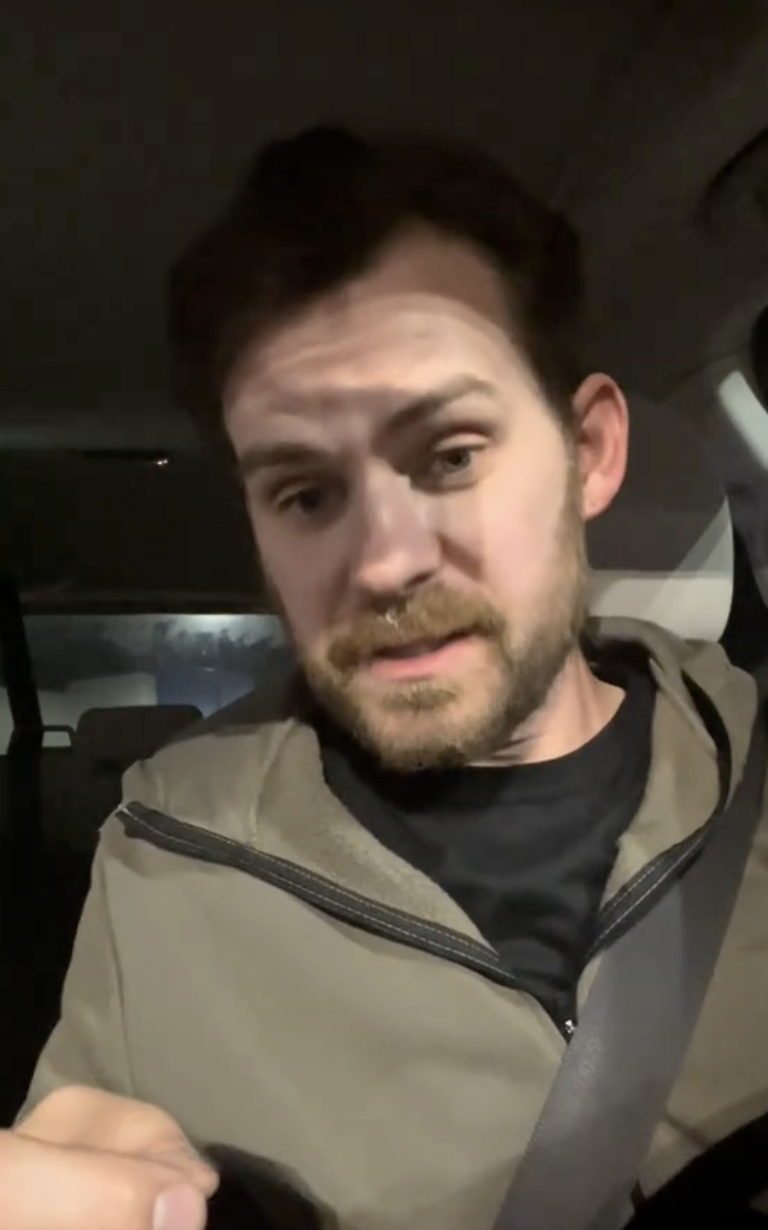 man sitting in his car