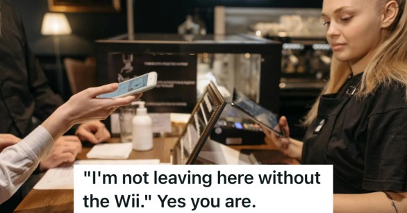 young woman taking a customer's payment