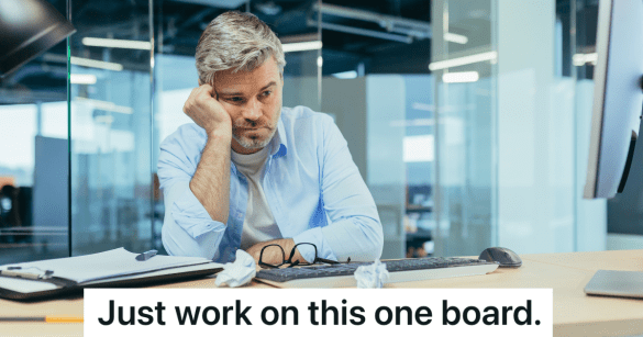 bored man sitting at his desk at work