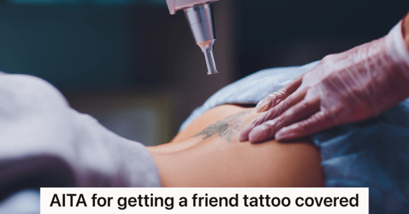 woman getting a tattoo on her back removed