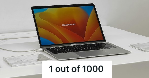 A MacBook laptop on display in the store