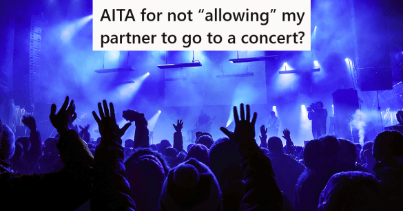 people with hands up at a concert