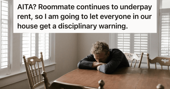 man looking stressed with his head down on the table