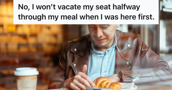 man sitting at a cafe with a croissant