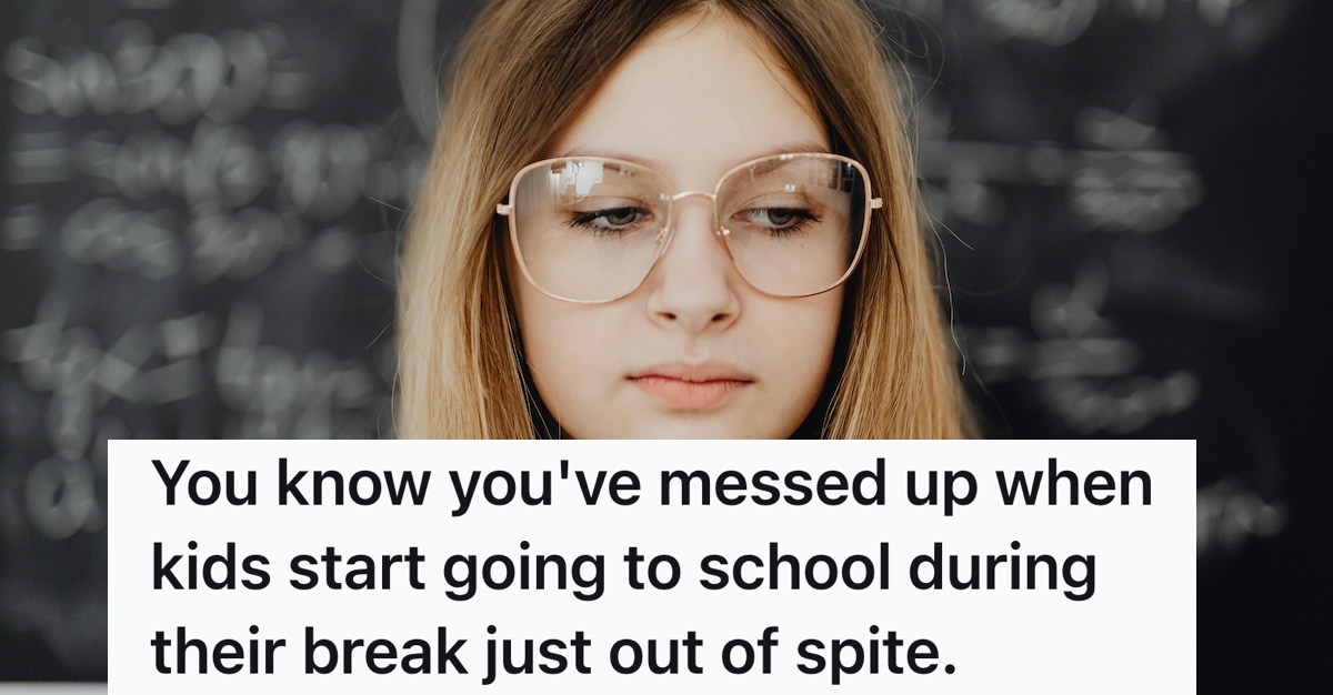 woman in glasses in front of blackboard