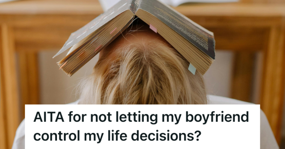 stressed college student sitting at their desk with book over face