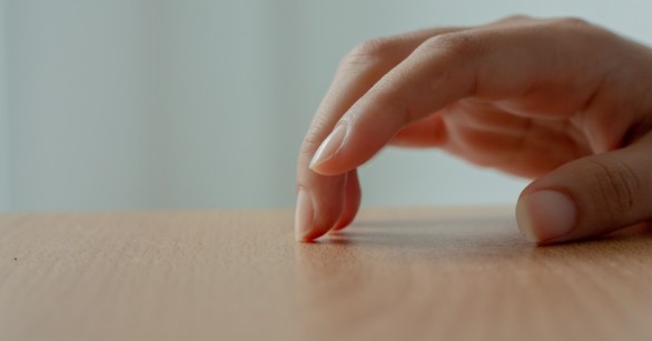 Fingers tapping on table