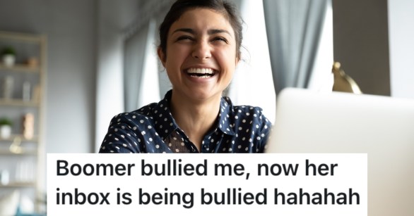 woman laughing working on a computer