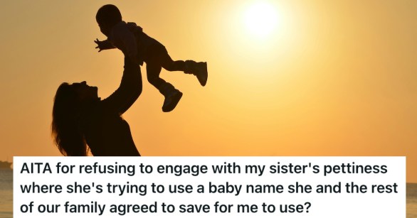 A baby held in the air against a sunset