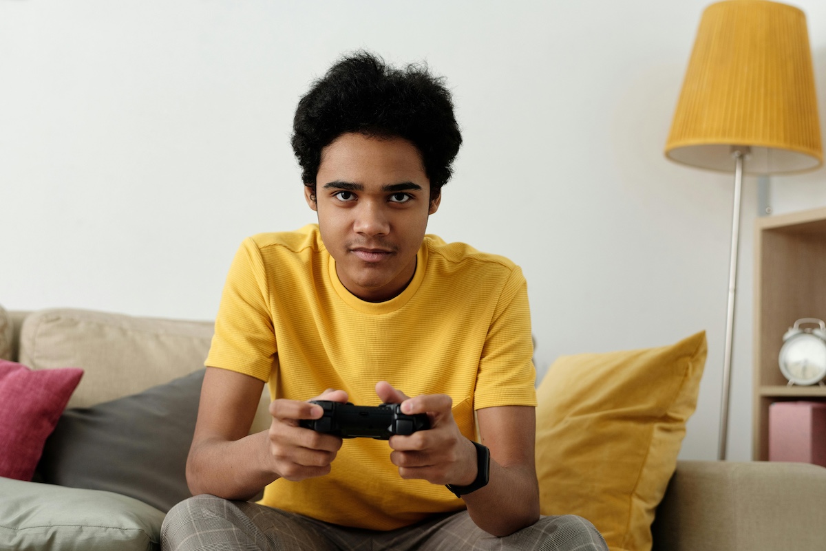 A teenager playing a video game