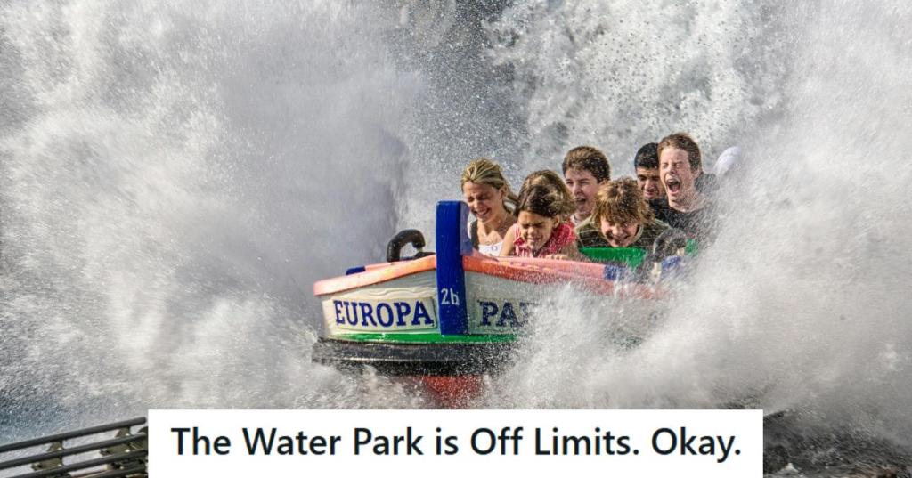 Teenagers riding a water ride at an amusement park