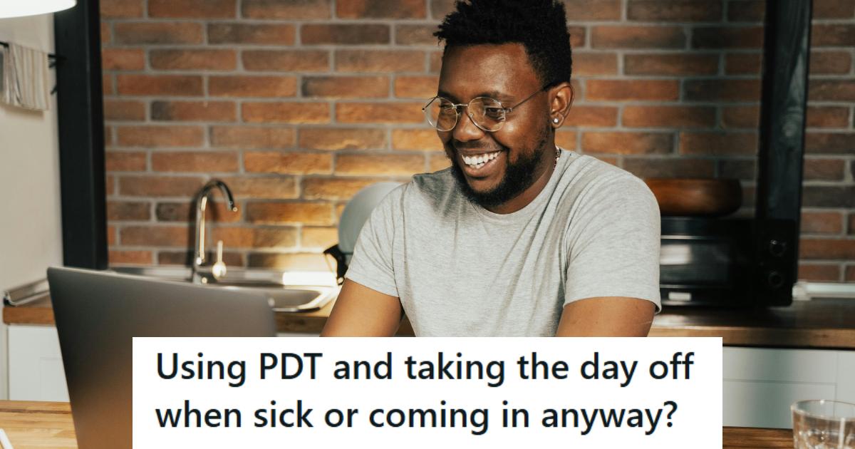African American man smiling as he works from home on the computer