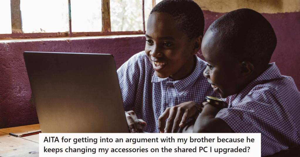 Two boys playing on a laptop