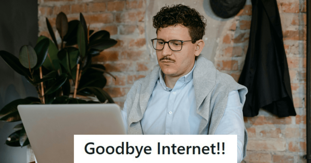 Man in blue shirt working on his laptop