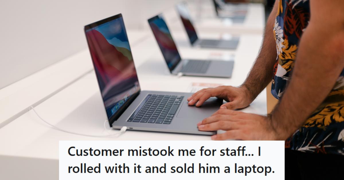 Man showing a customer how to use a laptop he wants to buy