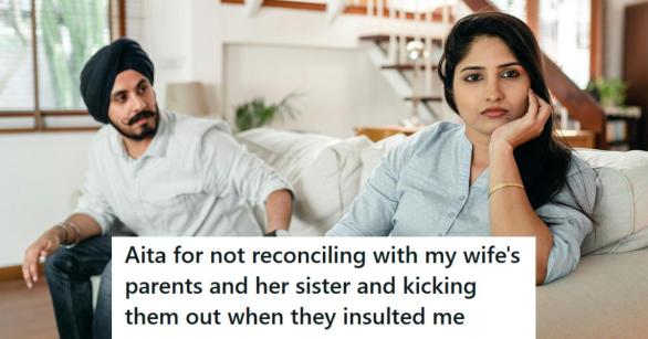 Indian man and his wife sitting on the couch having a tense discussion