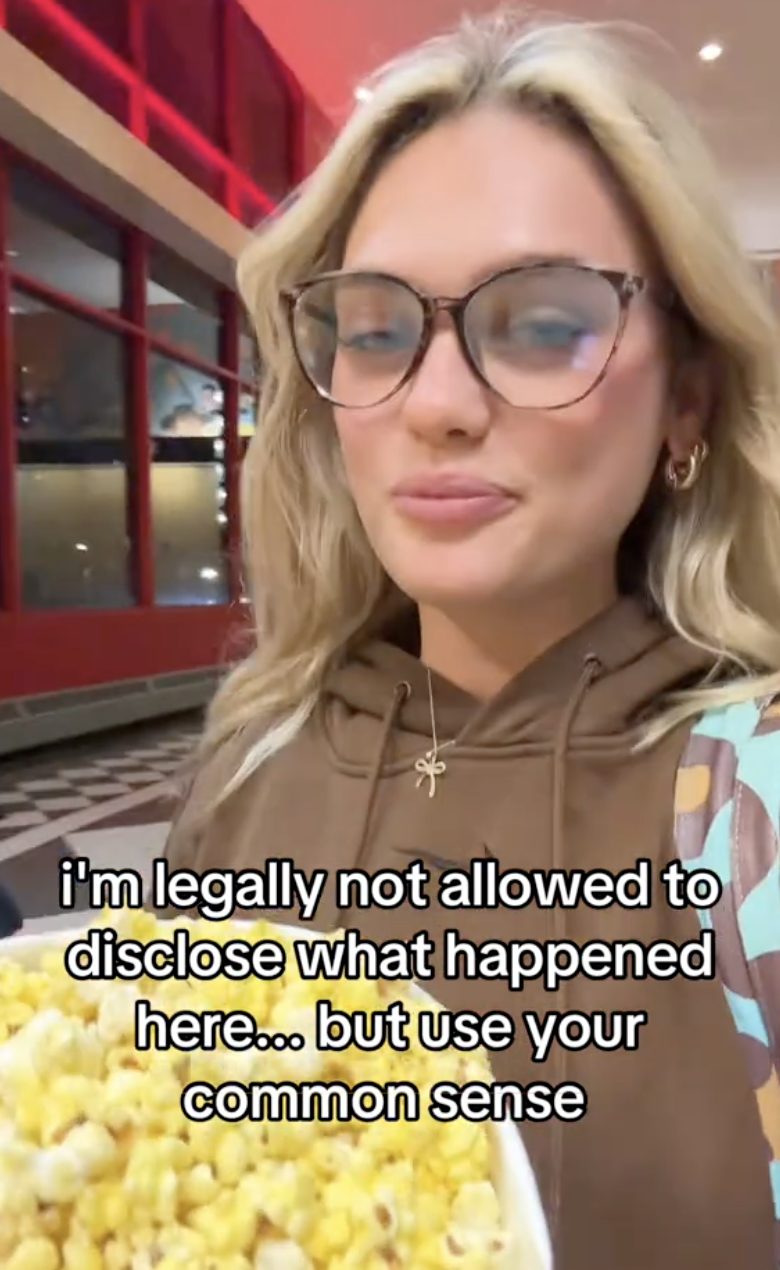 woman carrying popcorn in a theater