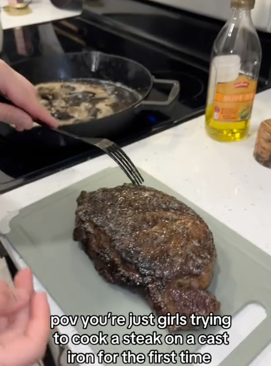 woman cooking a steak