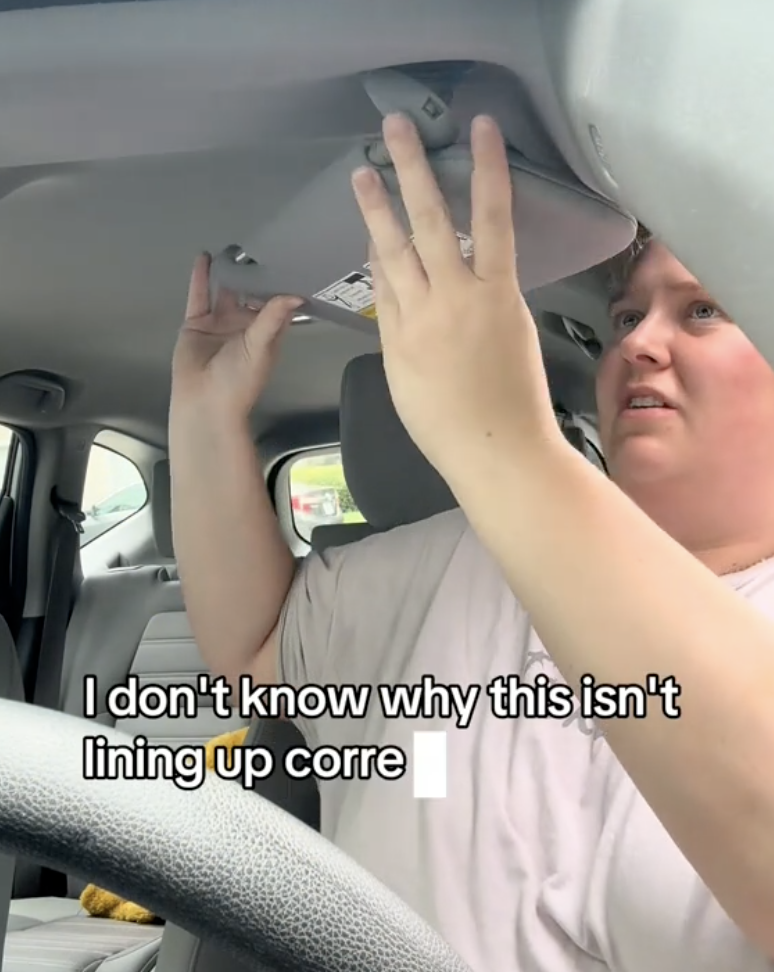 woman working on her car