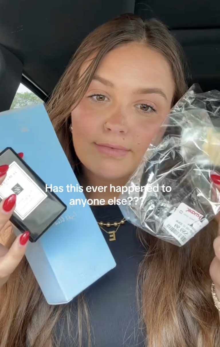 woman holding a bottle of perfume